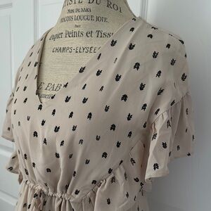 Caramela brand womens Beige dress with black pattern.